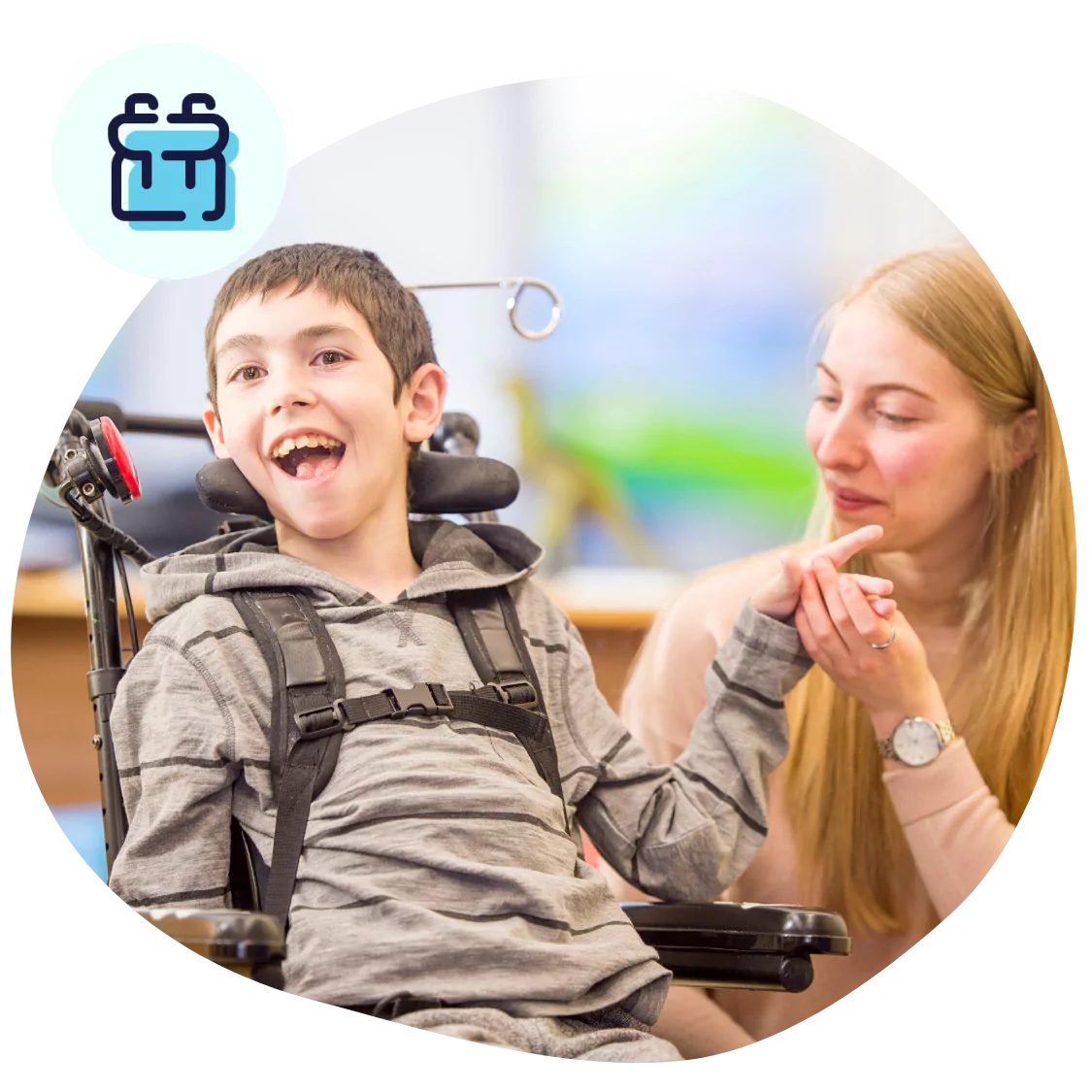 A disabled man sitting in his wheelchair and his support worker